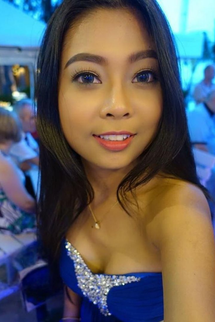 Woman in black holding a chihuahua by a pool table. Misa.