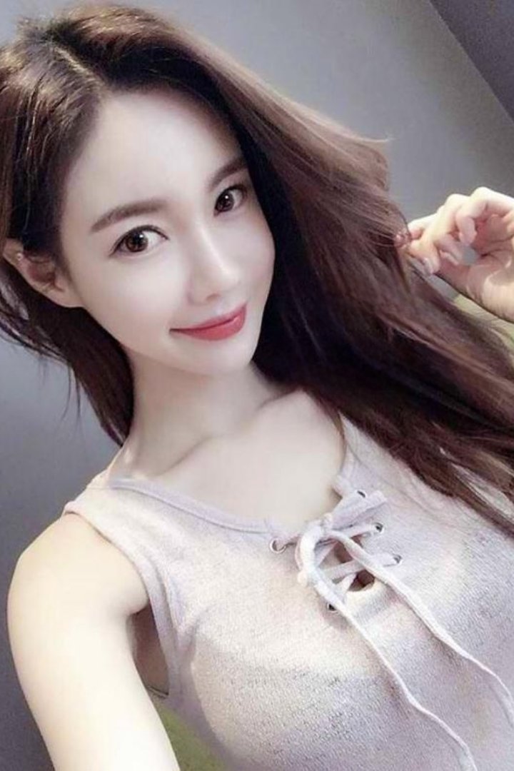 Woman in black holding a chihuahua by a pool table. Misa.