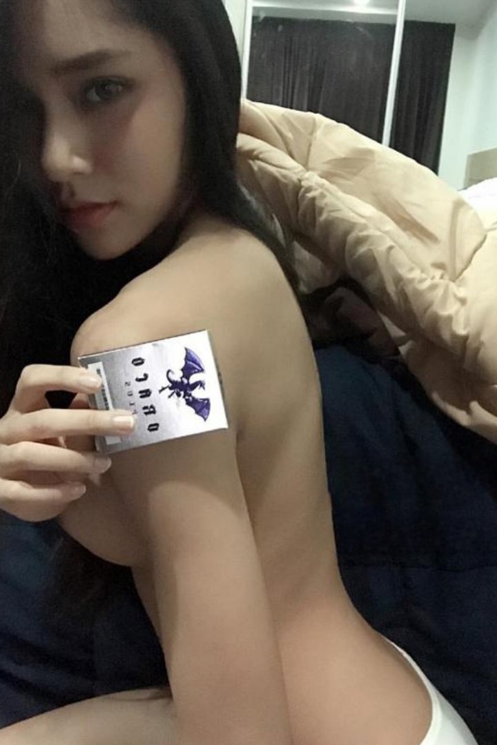 Woman in black holding a chihuahua by a pool table. Misa.