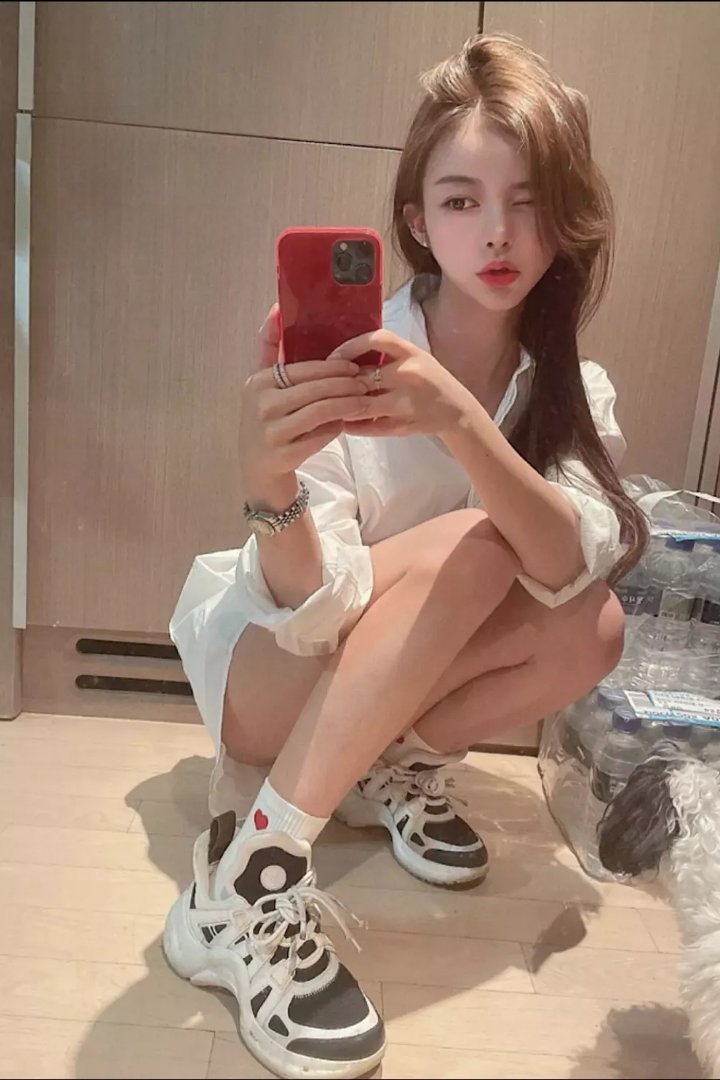 Woman in black holding a chihuahua by a pool table. Misa.