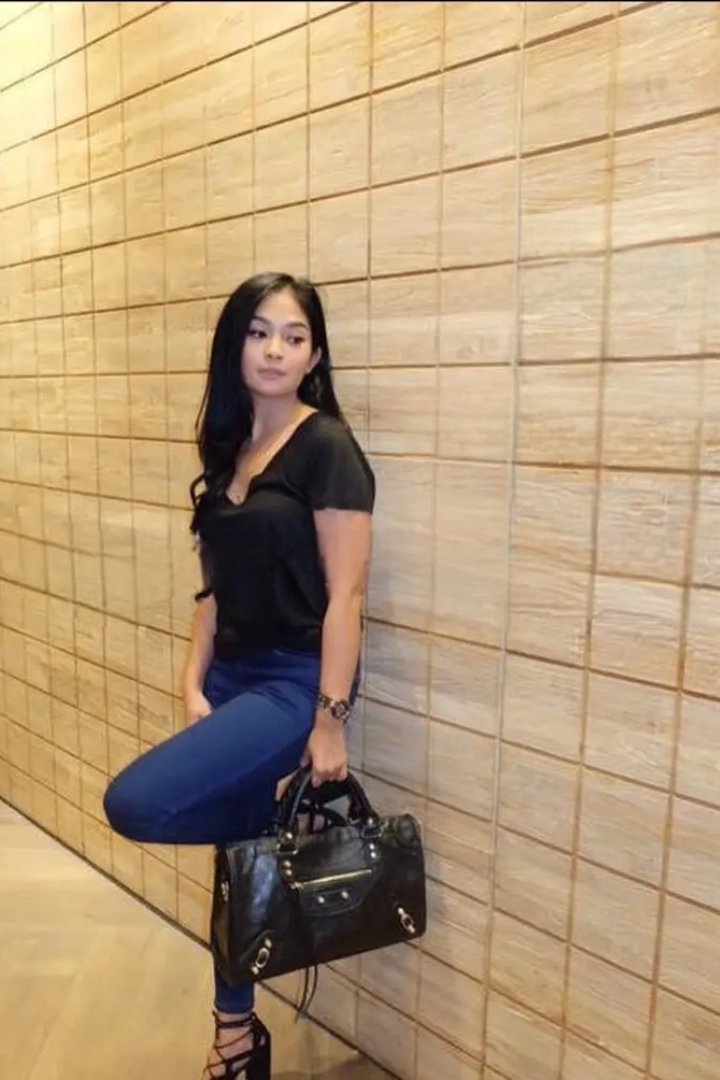 Woman in black holding a chihuahua by a pool table. Misa.