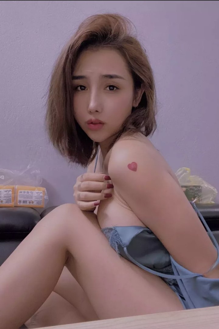 Woman in black holding a chihuahua by a pool table. Misa.